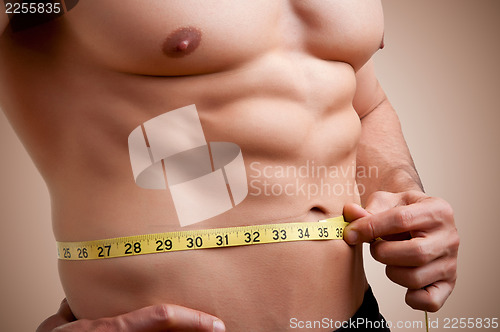 Image of Fit Man Measuring His Waist