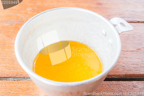 Image of Bakery melt butter measured in plastic  cup 