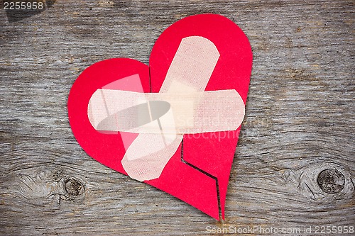 Image of Broken heart on the wooden background