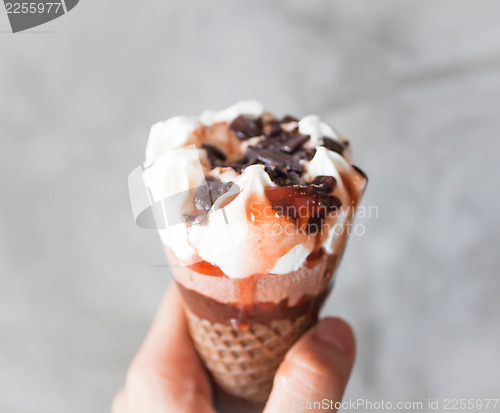 Image of Melted ice cream in waffle cone in hand