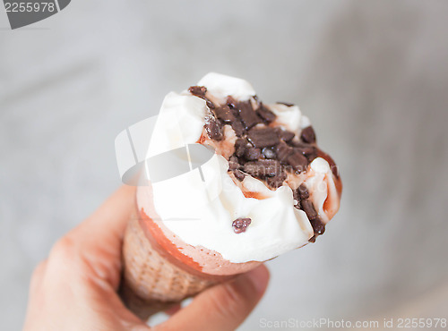 Image of Melted ice cream in waffle cone in hand