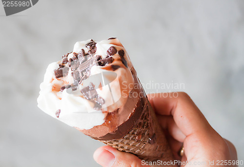 Image of Melted ice cream in waffle cone in hand
