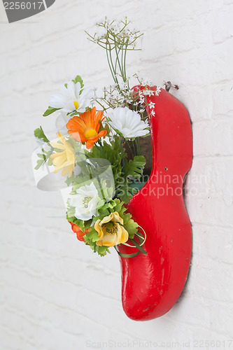 Image of Dutch wooden shoe with fake flowers