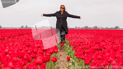 Image of Woman standing in a field of tulips