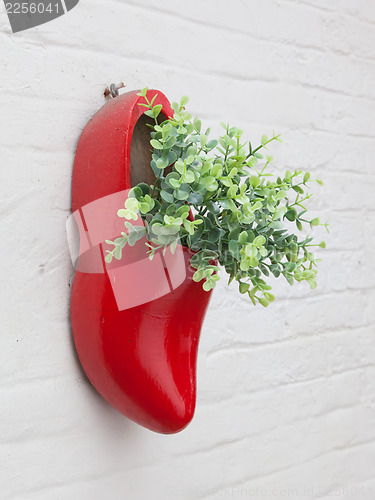 Image of Dutch wooden shoe with fake flowers