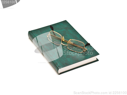 Image of Green book and glasses, isolated on white background