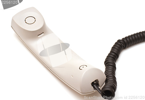 Image of Telephone receiver and cord on white