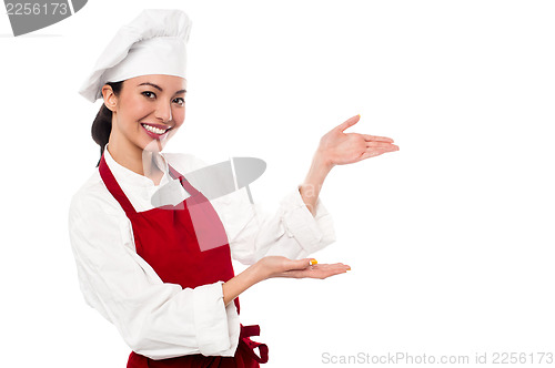 Image of Female chef presenting something