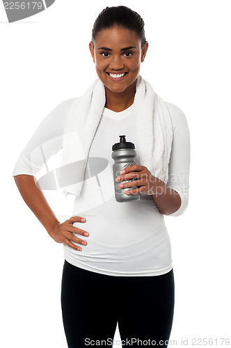 Image of Fitness freak holding sipper, towel around her neck