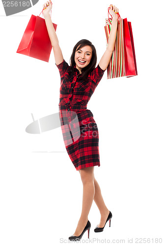 Image of Excited shopping girl having great fun