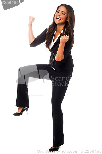 Image of Full length shot of an excited woman with clenched fists