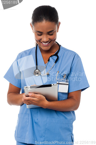 Image of Female physician operating tablet pc