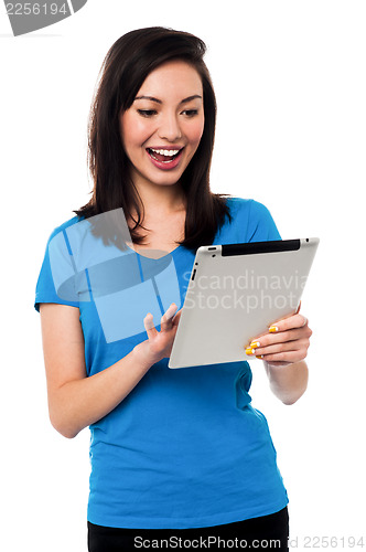 Image of Young girl playing games on tablet device