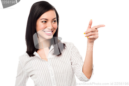 Image of Smiling business entrepreneur pointing away