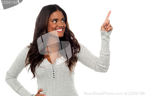 Image of Smiling pretty woman pointing away