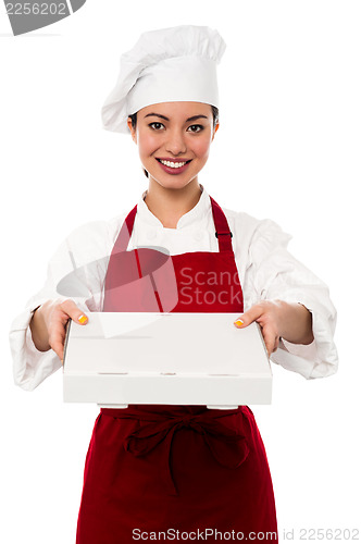 Image of Attractive asian female chef delivering pizza