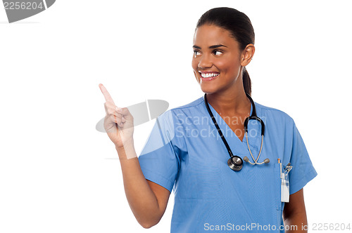 Image of Female physician pointing and looking away