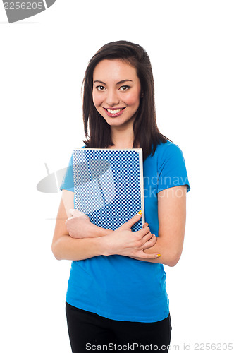 Image of Smiling young confident student holding notebook