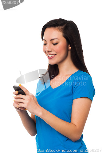 Image of Pretty girl sending text message to her boyfriend