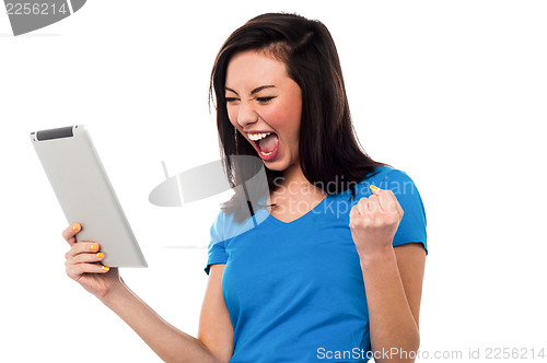 Image of Joyous girl clenching her fist in excitement