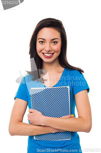 Image of Young girl holding notebook