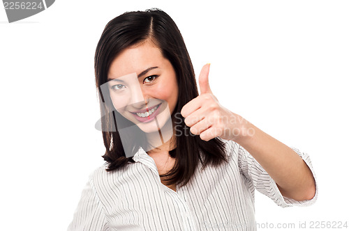 Image of Smiling young woman showing thumbs up