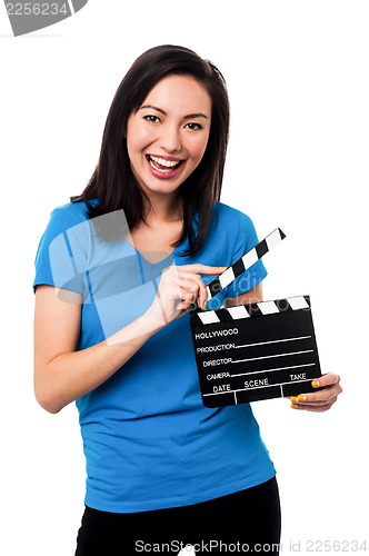 Image of Young girl holding clapperboard