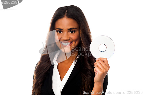 Image of Attractive woman in formals holding CD