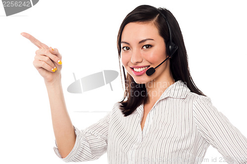 Image of Asian call center executive pointing away