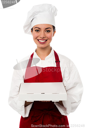 Image of Attractive asian female chef delivering pizza