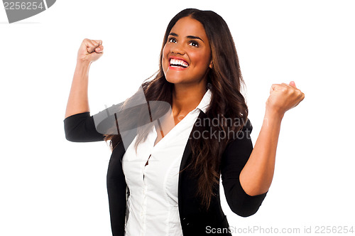 Image of Excited businesswoman with clenched fists