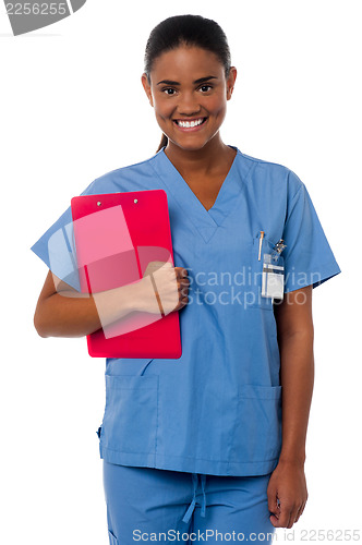 Image of Active female nurse holding clipboard, at duty