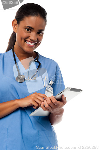 Image of Female physician browsing on tablet pc