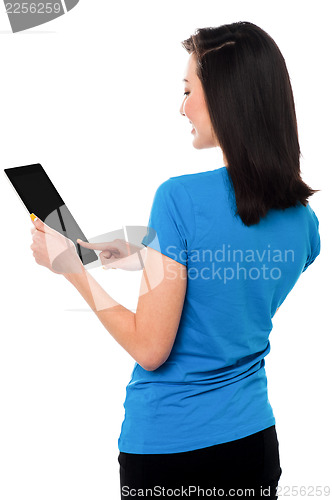 Image of Smiling attractive girl operating touch pad device