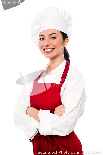 Image of Cheerful confident young female chef