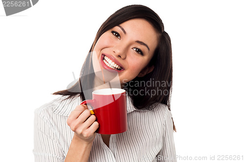 Image of Woman enjoying coffee during work break