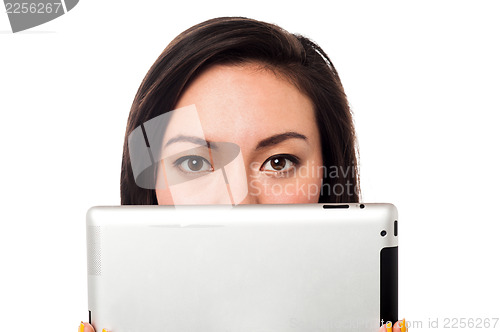 Image of Asian model hiding her face with tablet device