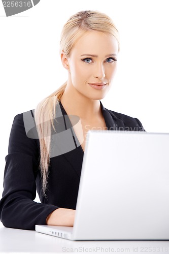 Image of Cute blond business woman working on laptop