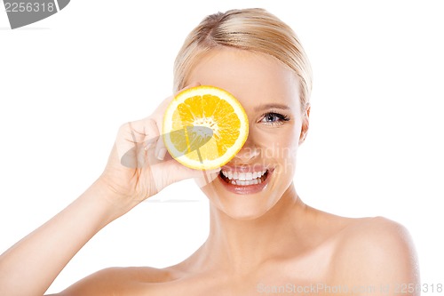 Image of Blond woman with beautiful smile holding orange