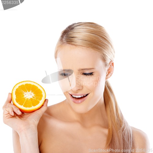 Image of Blond woman with beautiful smile holding orange