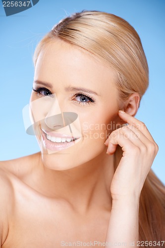 Image of Long haired blond woman portrait on blue