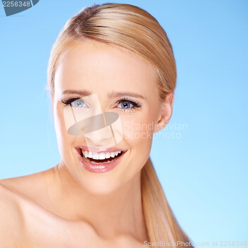 Image of Beautiful girl with big smile on blue