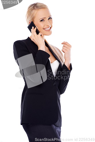Image of Happy blond business woman using her mobile