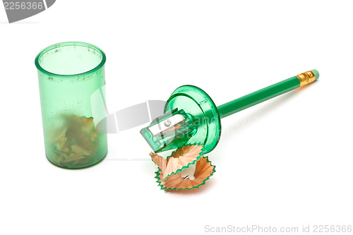 Image of Green sharpener and pencil on white background.