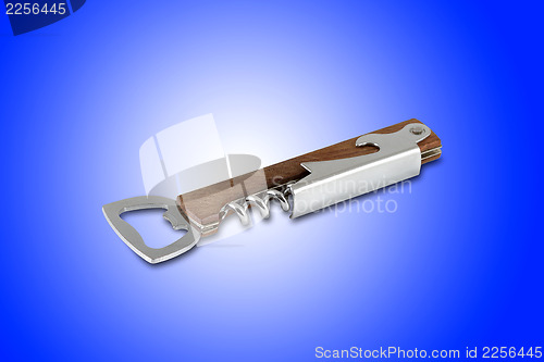 Image of Corkscrew and bottle opener tool, isolated on blue background