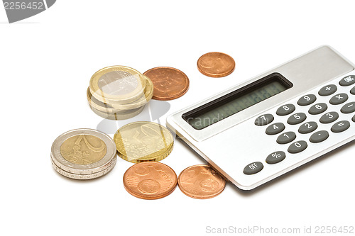 Image of Several euro coins and calculator on white background