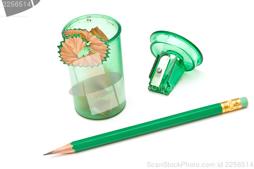 Image of Green sharpener and pencil on white background.