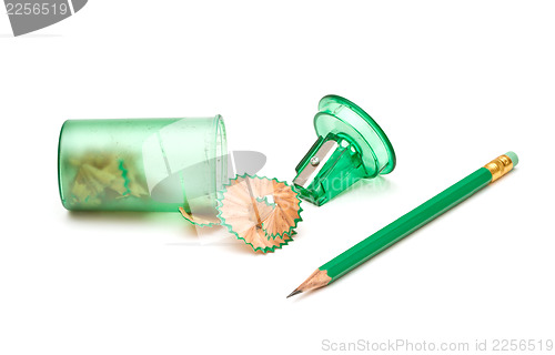 Image of Green sharpener and pencil on white background.