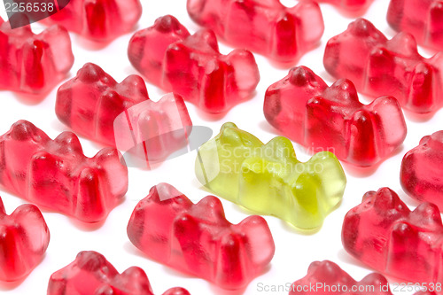 Image of Green gummy bear among red