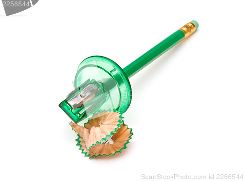 Image of Green sharpener and pencil on white background.